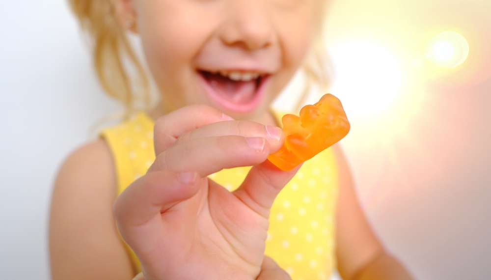 child eating gummy bear