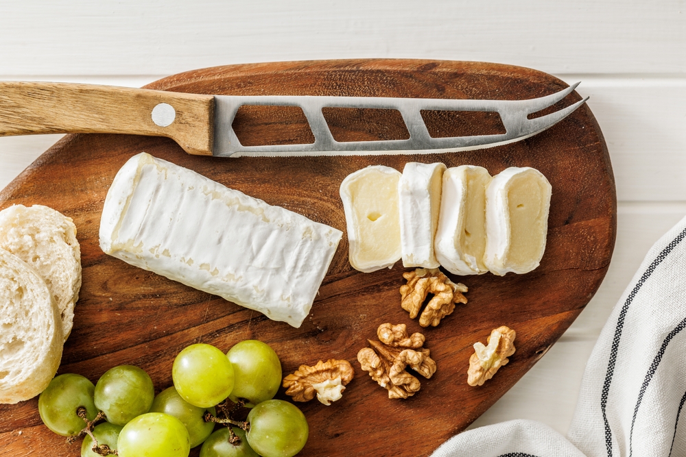 Artisan Brie cheese with nuts and grapes