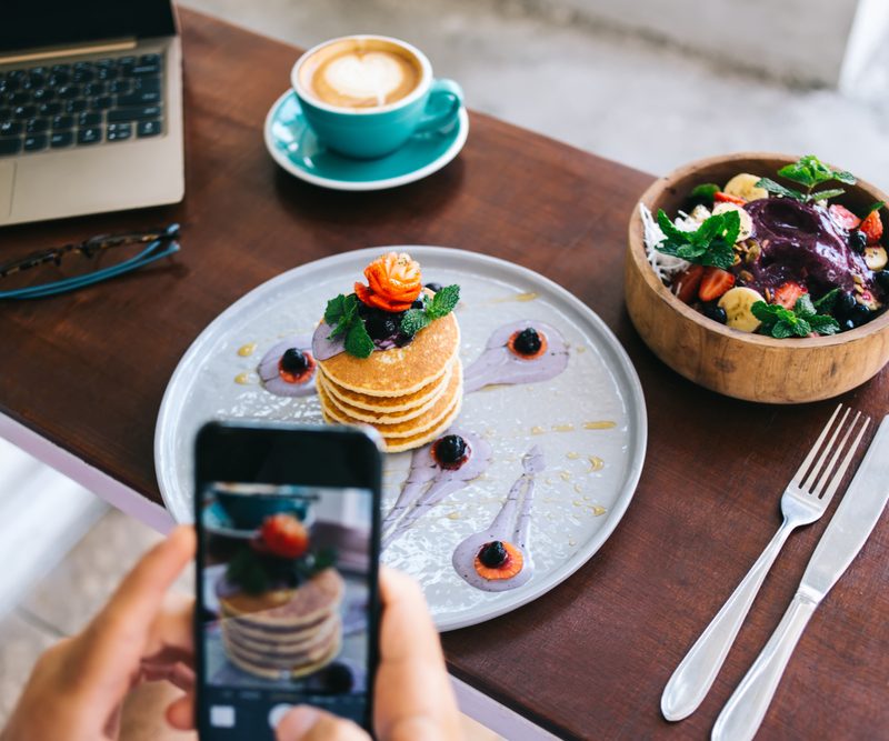 Generation Z photographing pancakes stack