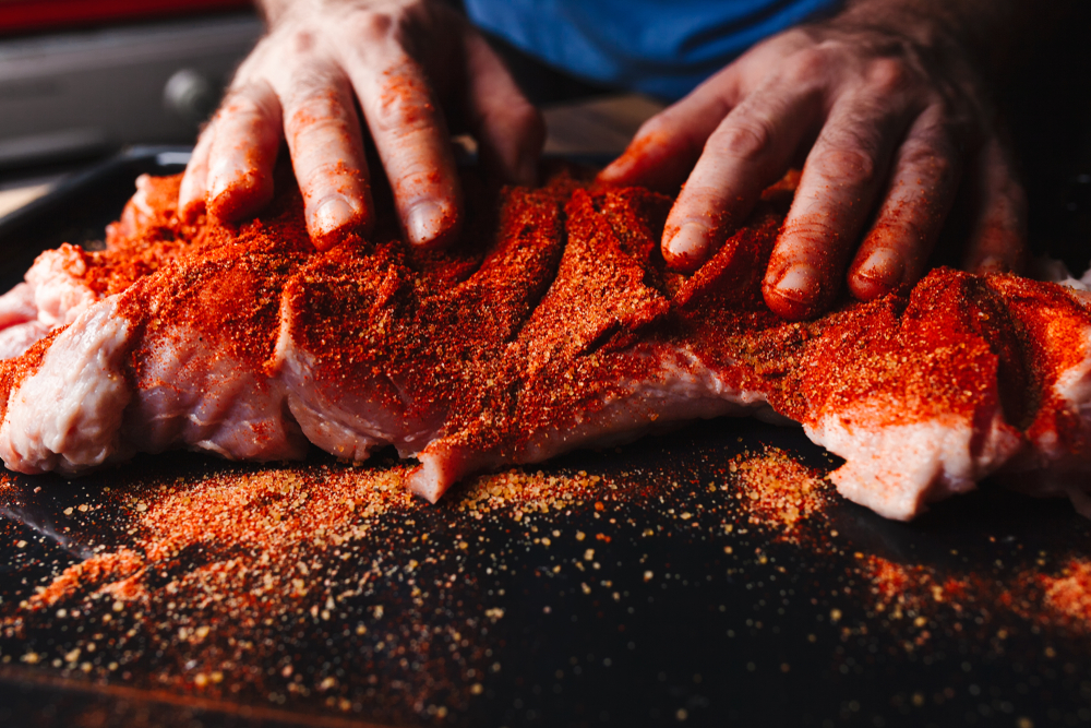 Applying rub of different spices and herbs