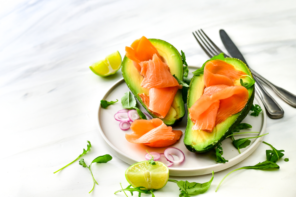 Keto- friendly breakfast salmon and avocado with arugula and lime