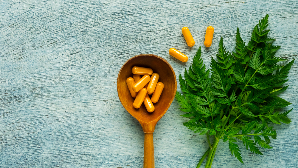 Curcumin - nutraceutical capsule and green leaf