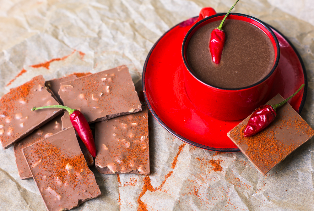 Red cup of hot chocolate with red pepper