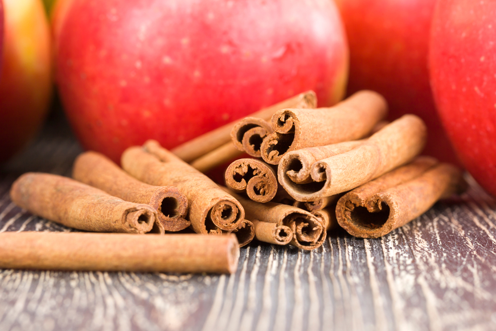 Red ripe and juicy Apple with cinnamon sticks, making a delicious dessert of fruits and spices