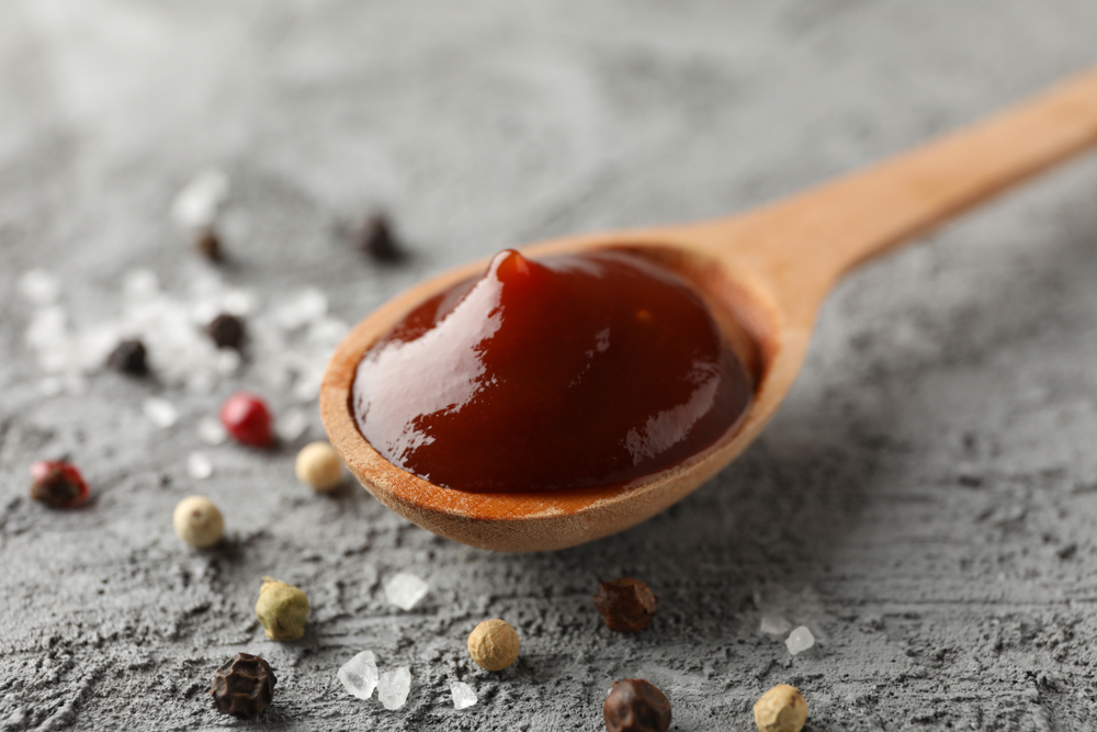 Spoon of delicious barbeque sauce, ingredients
